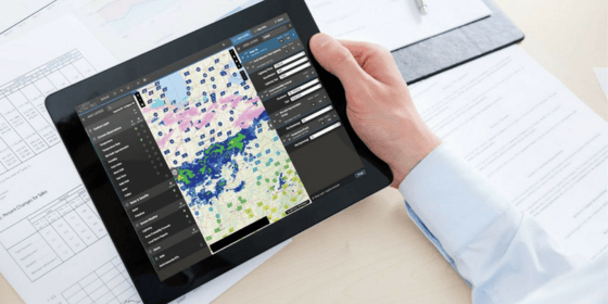 Someone using a real-time weather map on their tablet