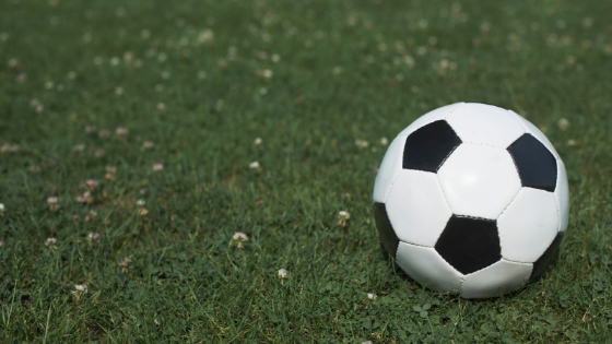 A black and white soccer ball on turf